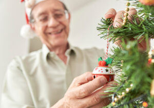 importance of social connections for seniors, man hanging ornaments