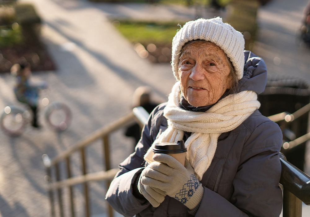 senior health in winter, older woman holding coffee