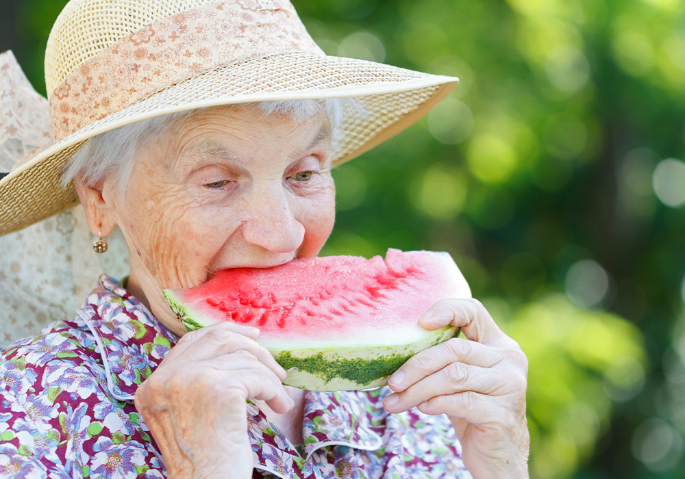 summer safety tips for seniors, woman eating watermelon